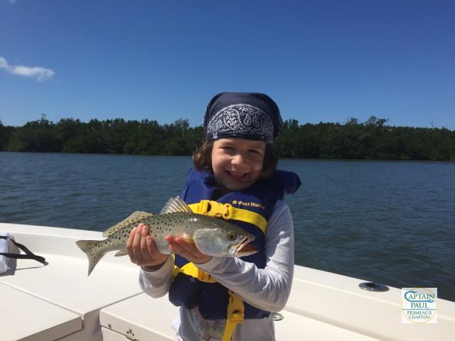 young girl holding a seatrout in PIne Island Sound Sanibel FL